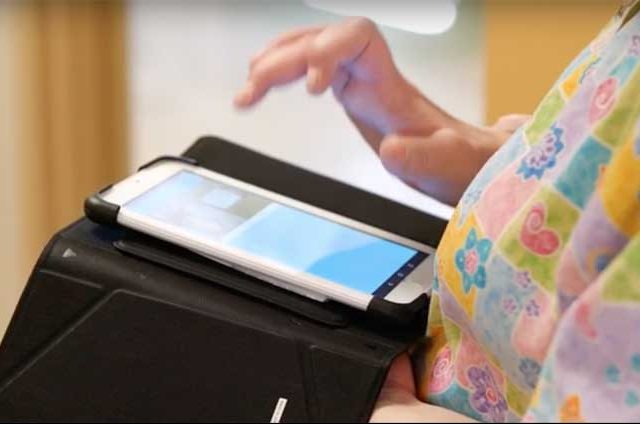 close up of hand touching an ipad