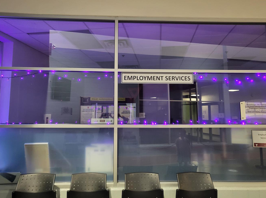 Office windows at the Employment Services Office, YMCA Peterborough, lit purple and blue