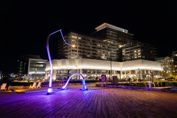 Get Drink Fall Down Sculpture located in Halifax, Nova Scotia is lit in purple and blue, supporting Light It Up! for NDEAM